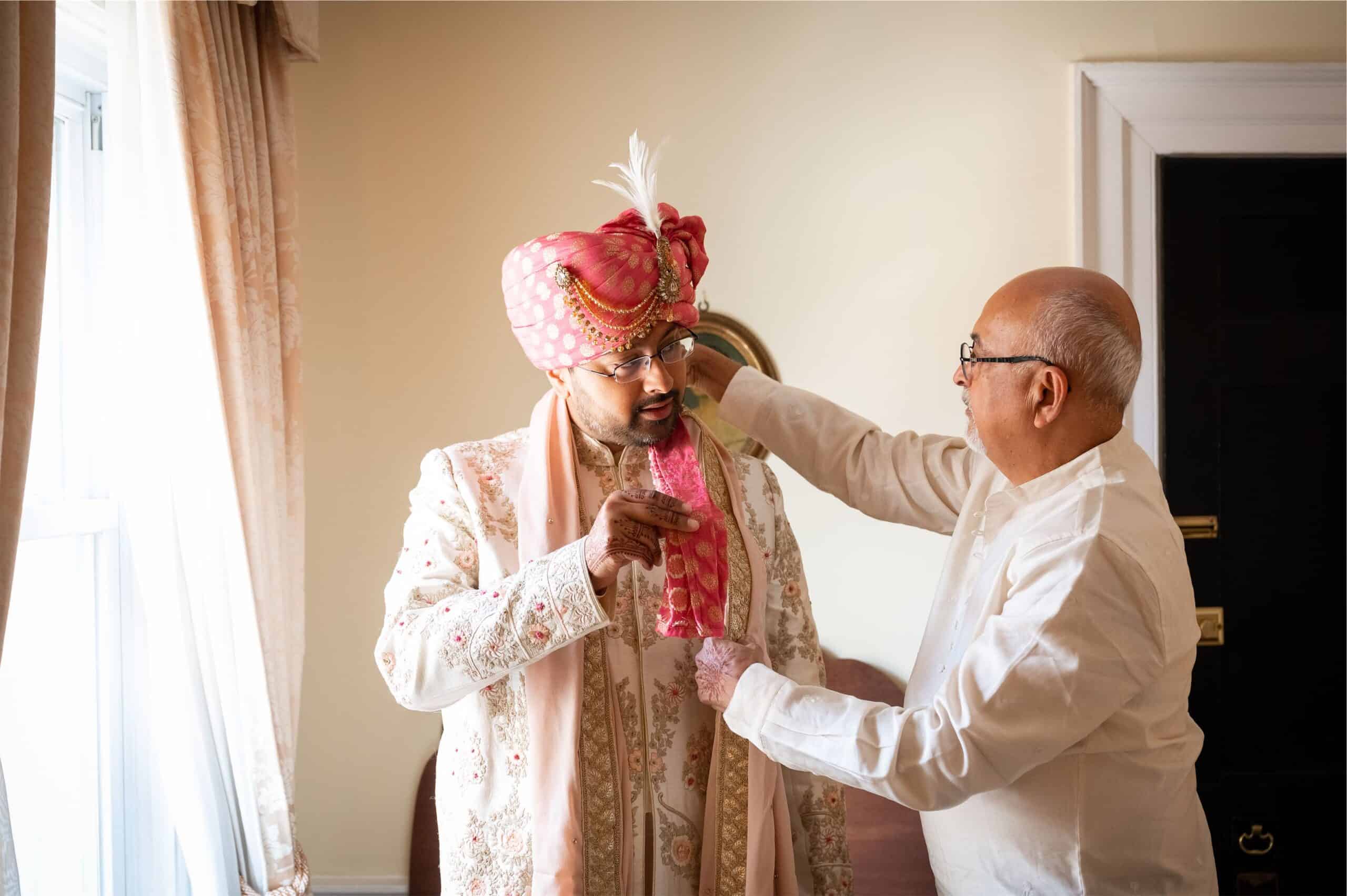 Vibrant Indian groom getting ready for wedding, wearing traditional attire and turban, captured by Zolana Weddings.