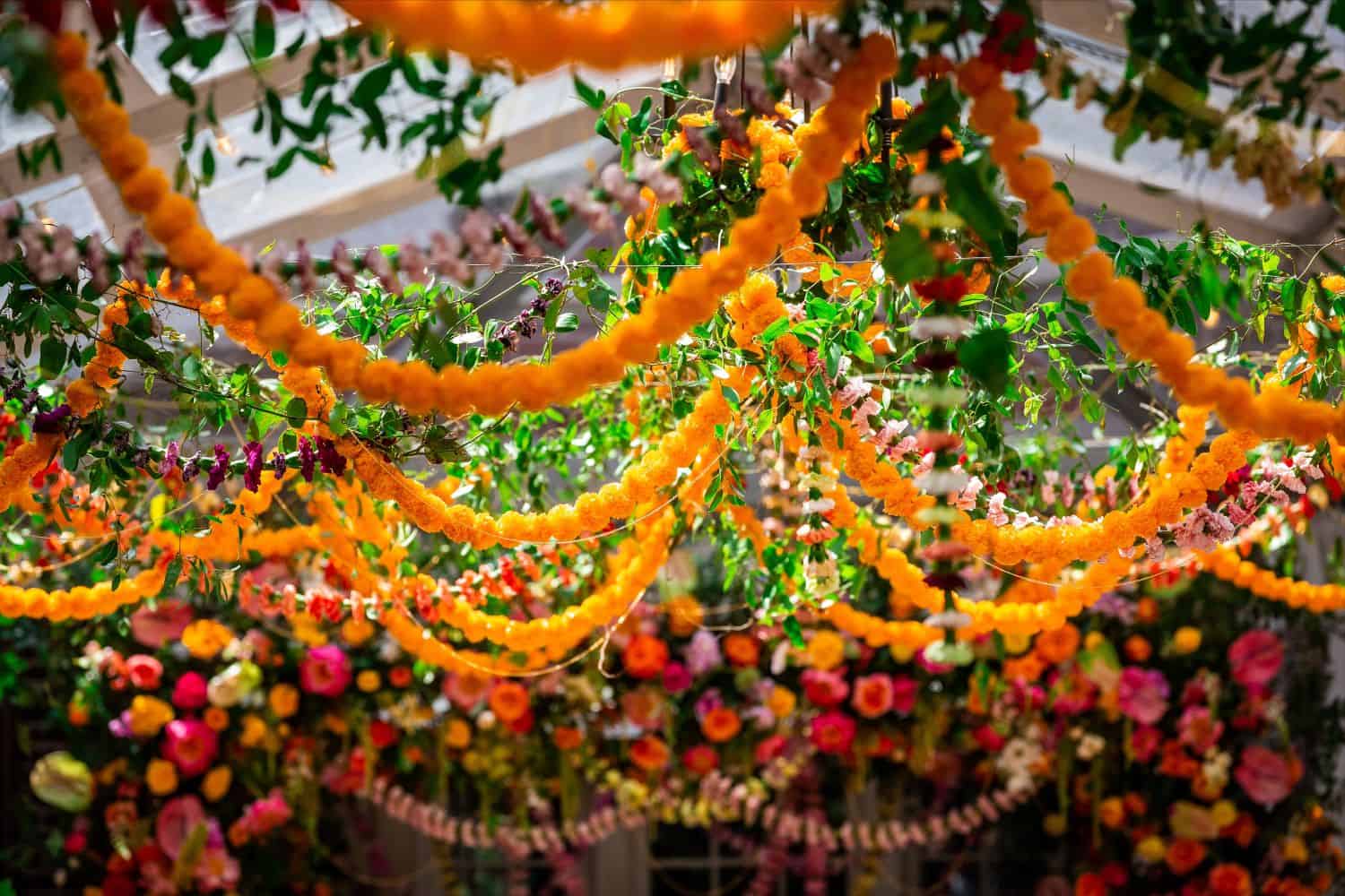 Bright, lively floral wedding decoration with vibrant flowers and garlands at Zolana Weddings.