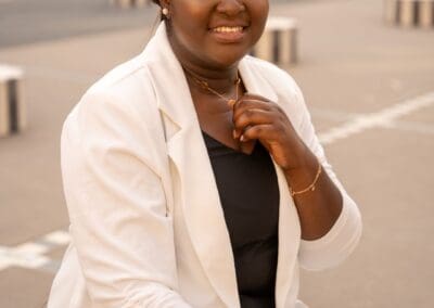 Beautiful woman smiling in formal attire, outdoor setting, wedding celebration, Zolana Weddings.
