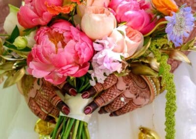 Beautiful bridal bouquet featuring pink peonies and mixed blooms for wedding decor.