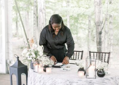Beautiful wedding table arrangement with white flowers, candles, and rustic decor.